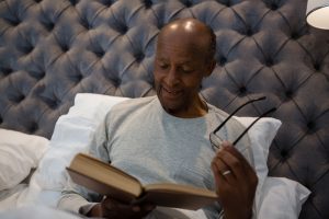 man reading in bed